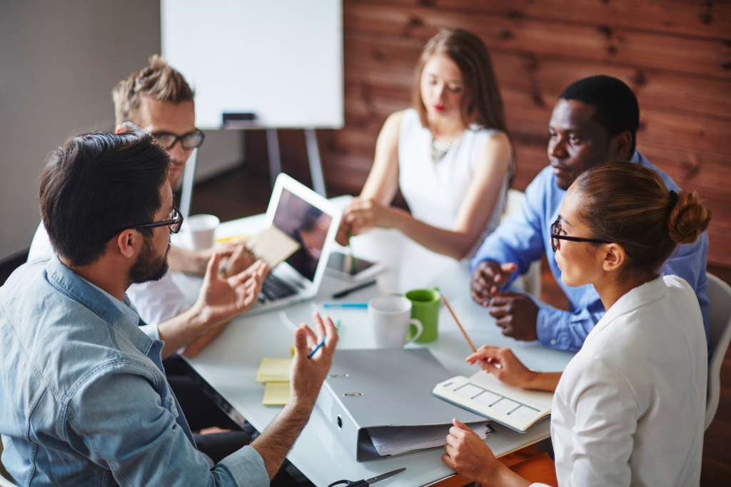Image of a group of people discussing a project.