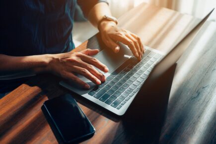 Business man typing on a laptop