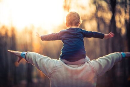 Child sat on shoulders of grandparent