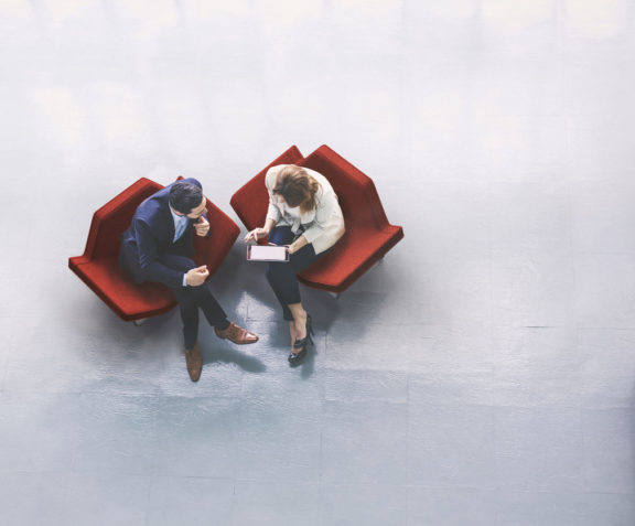 Overhead view of two business persons in the lobby