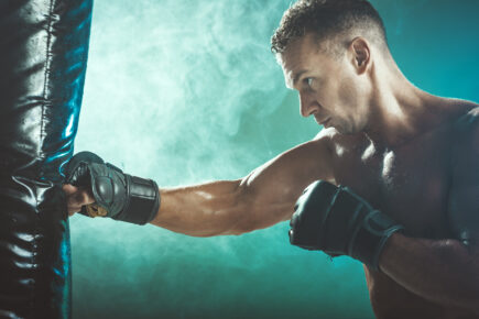 Boxer hitting a boxing bag.