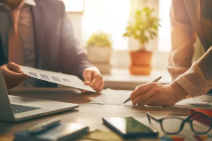 Image of 2 people looking over a document together