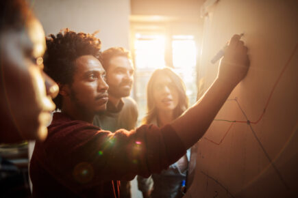 Group of business people analyzing a graph in the office.