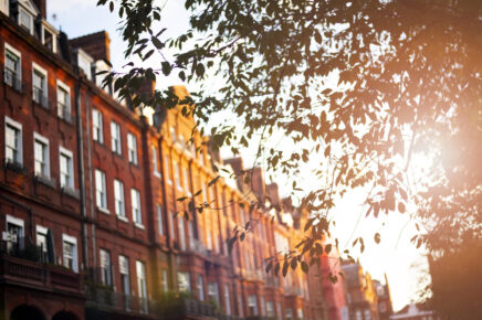 (selective focus) Beautiful red apartments illuminated at sunset in the Chelsea district in London, United Kingdom.