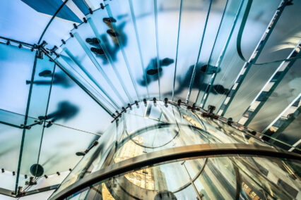 People walking on transparent glass staircase