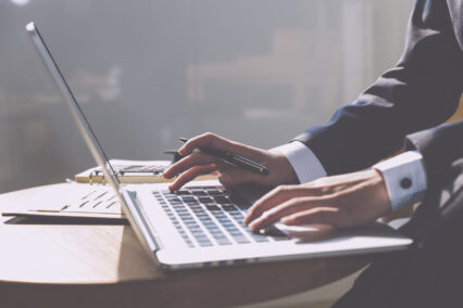 A person typing on a laptop