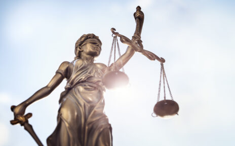 Lady Justice with scales of justice and sky background