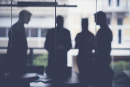 Silhouette business people discussing in meeting room