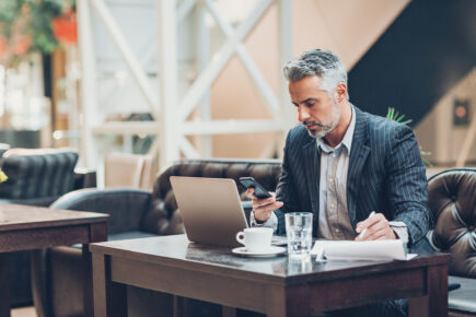 Mature businssman working in the lobby