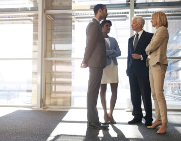 Colleagues standing talking