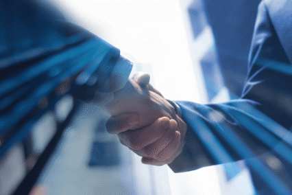 Corporate hands shaking